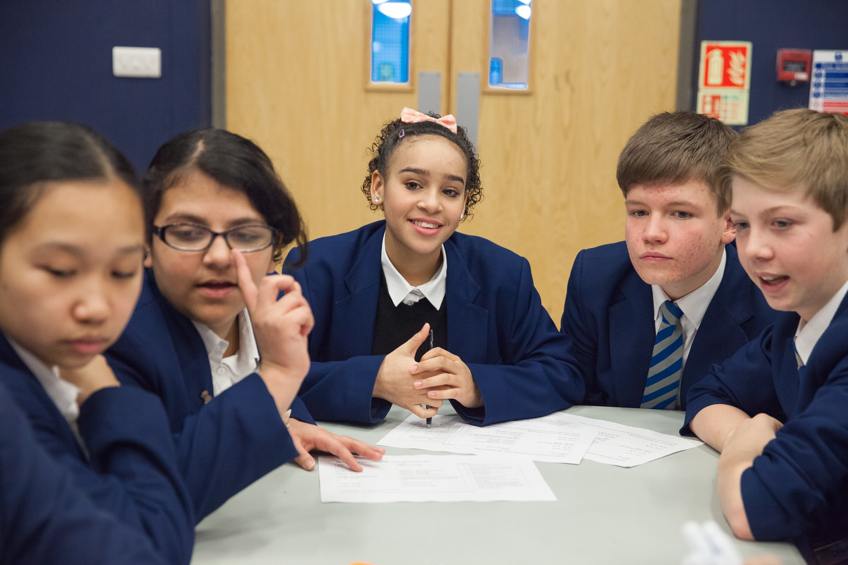 Young students sitting around a table