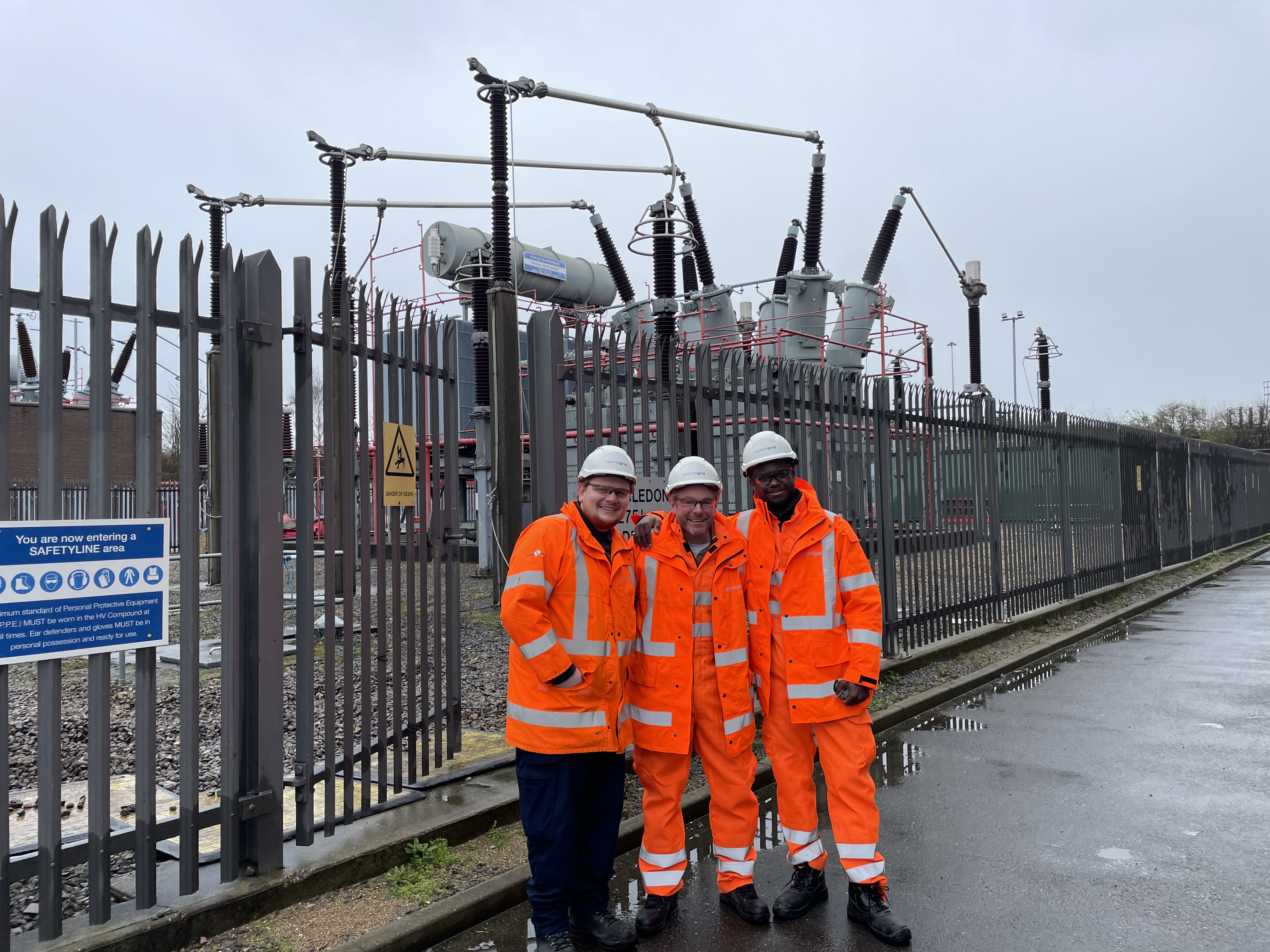 Three people at a substation in PPE