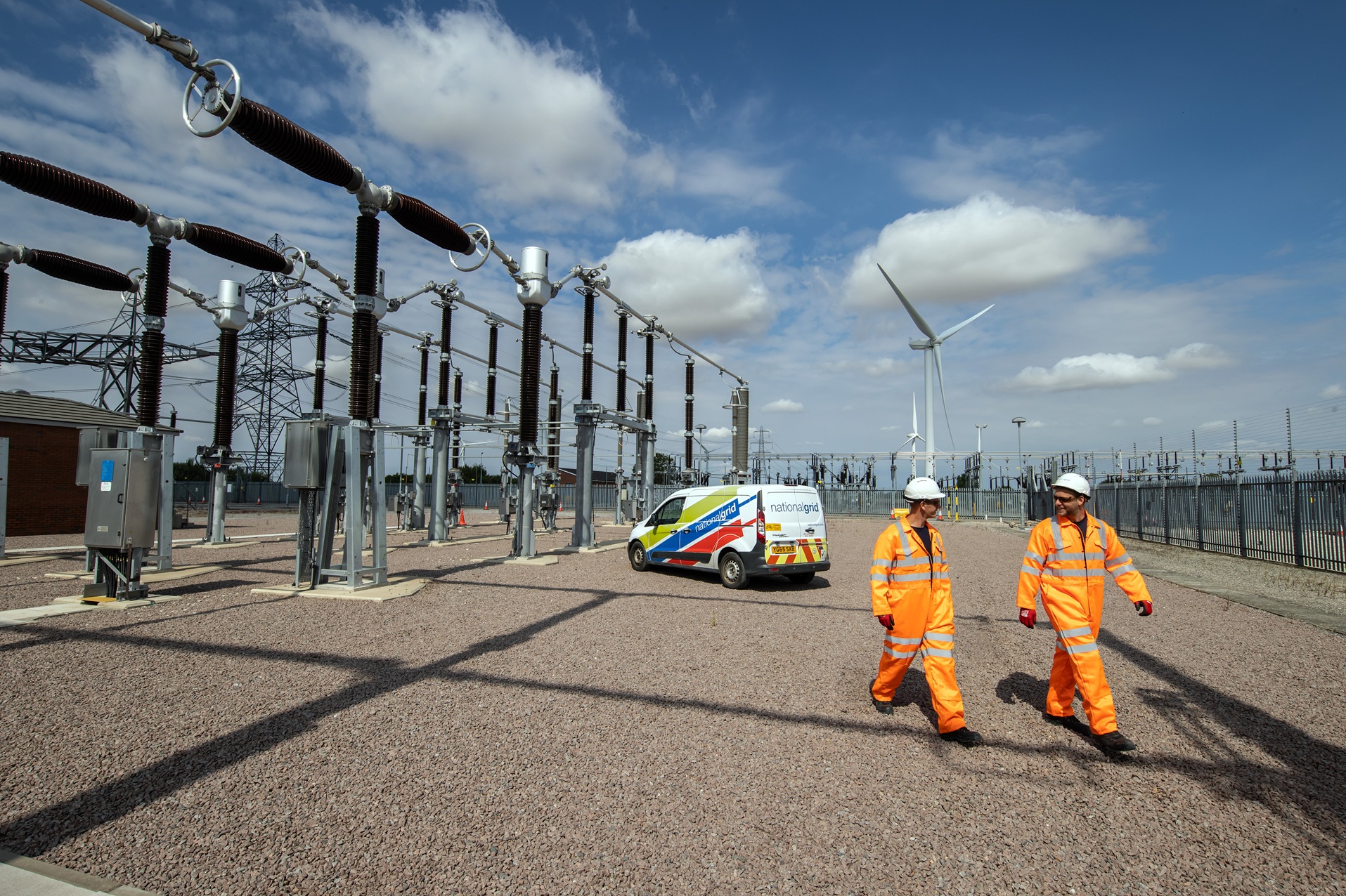 Workers walking near substation