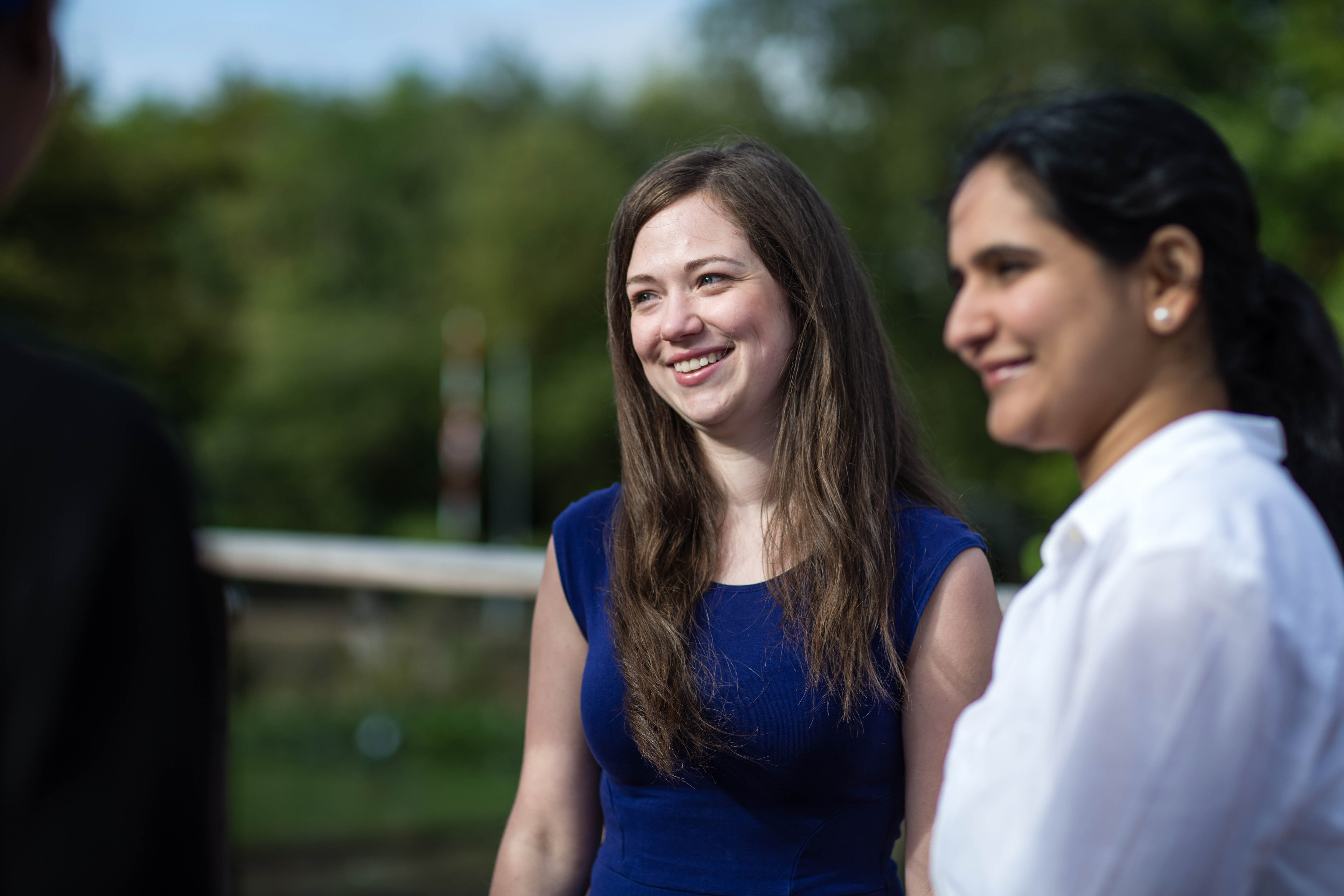 Two National Grid employees standing outside against a green background - Our people