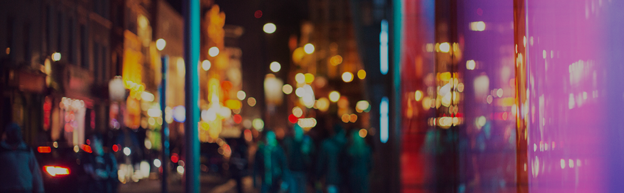 A blurred but well-lit cityscape