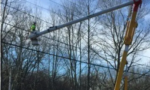 Utility bucket truck working on lines