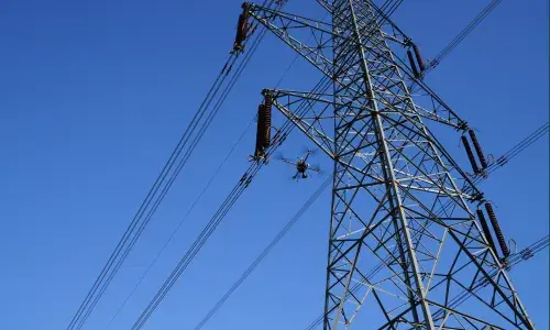 A drone working near a transmission tower