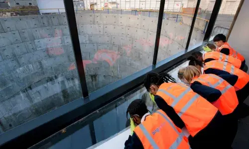 School pupils in PPE look into one of the LPT tunnel shafts