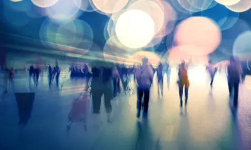 Fuzzy images of people walking in light