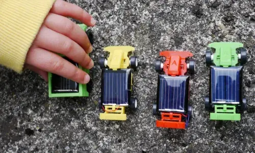 Child playing with toy cars