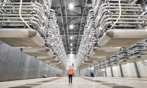 Engineer wearing PPE standing in the valve hall of the IFA2 interconnector