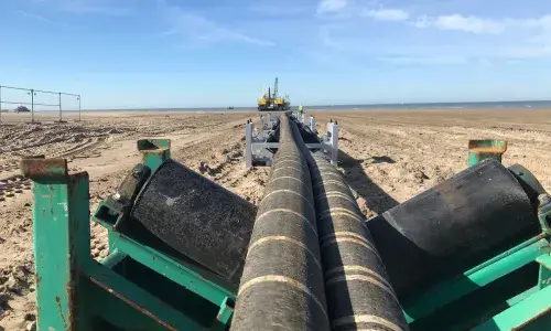 Interconnector cables being pulled across a beach - used for the National Grid article 'Connecting electricity systems for a greener Britain'