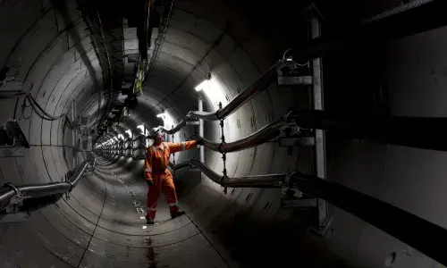 National Grid engineer inspecting the inside of a metallic tunnel structure 