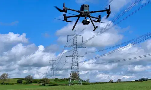 Drone inspecting high-voltage overhead power lines