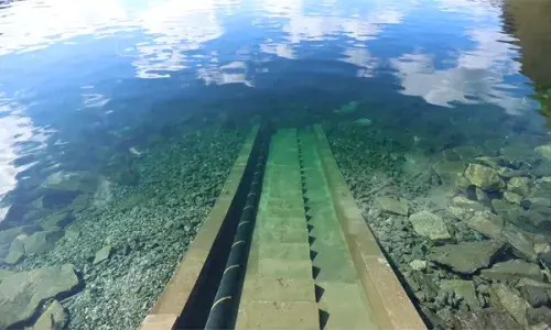 North Sea Link interconnector cable descending into the sea from the shore