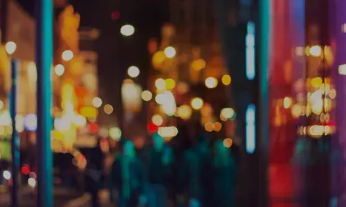 A blurred but well-lit cityscape