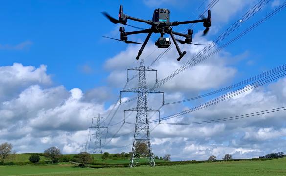 Drone inspecting high-voltage overhead power lines