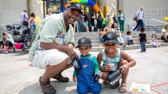 Father and sons outside the Brooklyn Public Library, New York