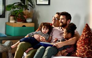 Cheerful family with young children on sofa - 300x190.jpg Cheerful family with young children on sofa