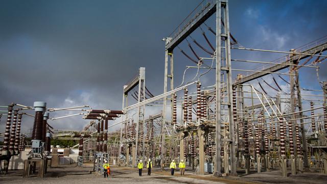 EnergyExplained_WhatIsSubstation_640x360_0.jpg Engineers wearing PPE walking through an electricity substation