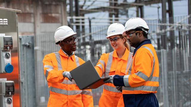 NGEngineers_Substation_640x360.jpg Three National Grid engineers wearing full PPE looking at a laptop at a substation