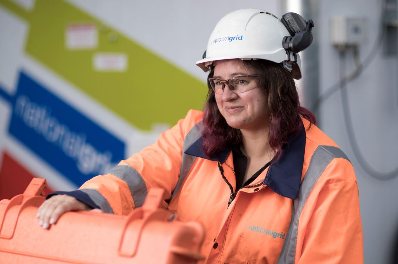 National Grid engineer wearing PPE opening an orange box