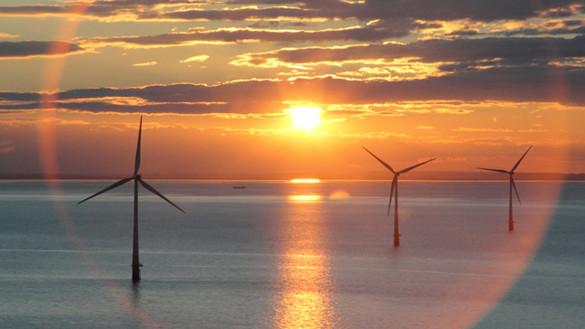 EnergyExplained_OffshoreWindPower_585x329.jpg Offshore wind turbines against sunset