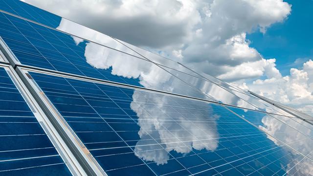 SolarPanelsBeneathBlueCloudySky_Getty1263473286_640x360.jpg Solar panels beneath a blue, cloudy sky with the clouds reflecting in the panels